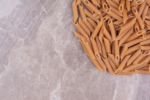 Homemade organic pastas isolated on the marble surface