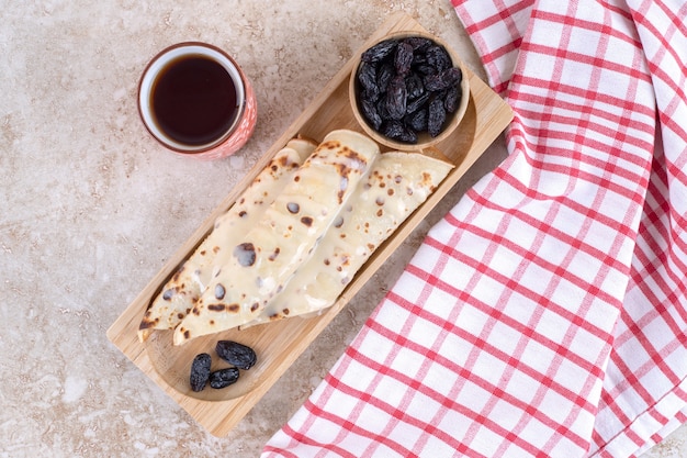 Homemade pancakes roll with raisin and condensed milk