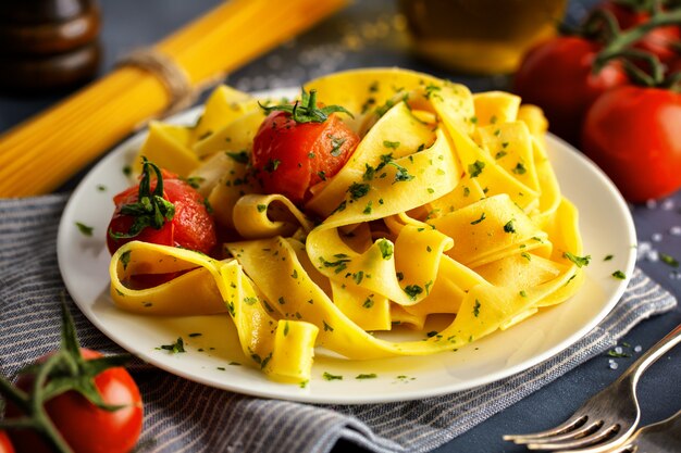 Homemade pasta with herbs and tomatoes