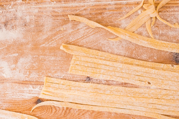 Homemade pasta on wooden background
