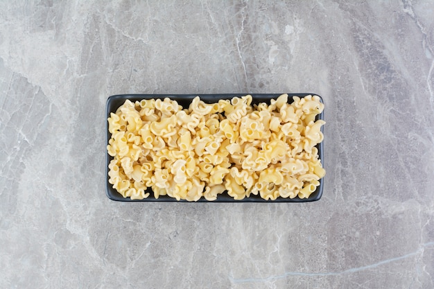 Homemade pastas in a black ceramic platter