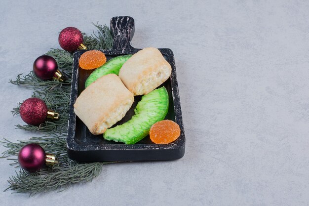 Homemade pastries and marmalades on black board. 