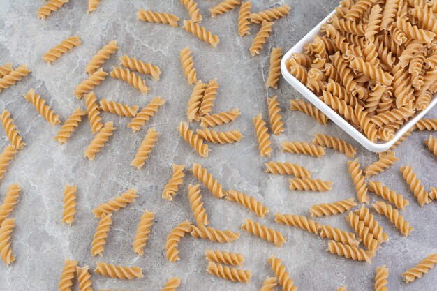 Homemade penne pastas in a white ceramic platter