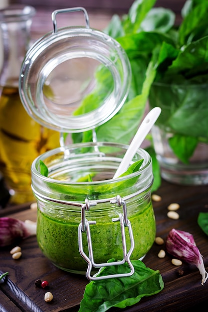 Free photo homemade pesto sauce fresh basil, pine nuts and garlic on wooden surface. italian food.