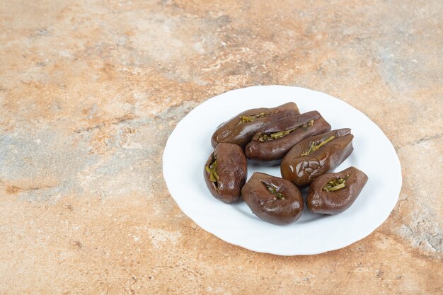 Homemade pickled eggplants on white plate