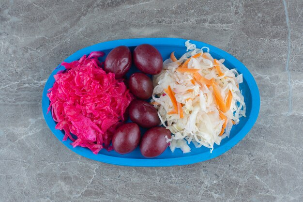 Homemade pile of sauerkraut on blue wooden plate