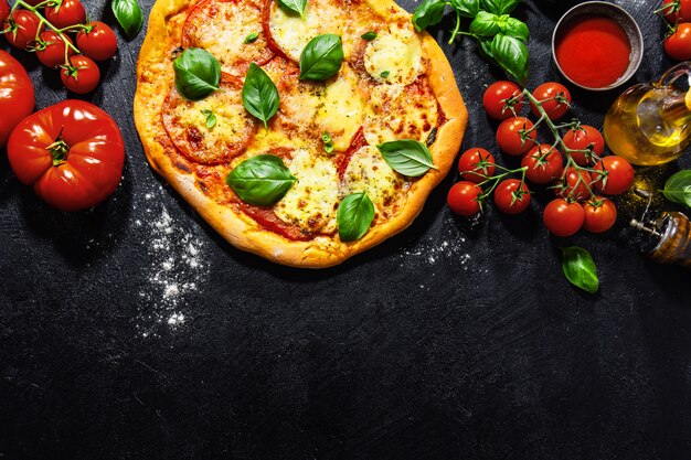 Homemade pizza with mozzarella on dark background