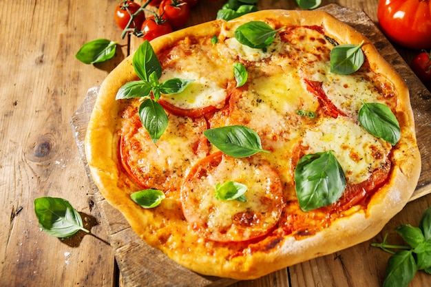 Homemade pizza with mozzarella on wooden background