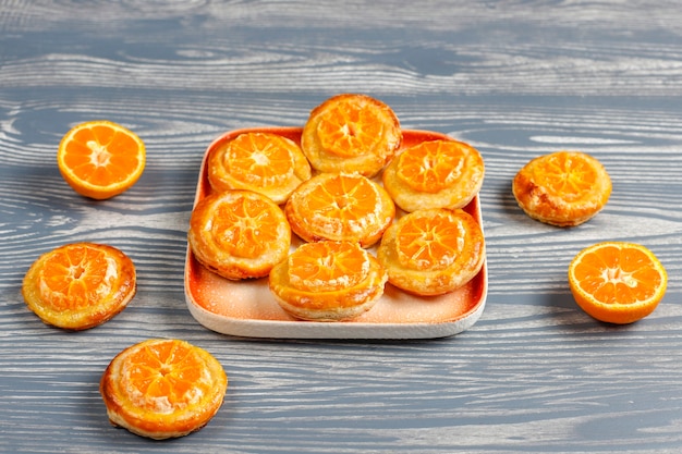 Homemade puff pastry with tangerine slices.