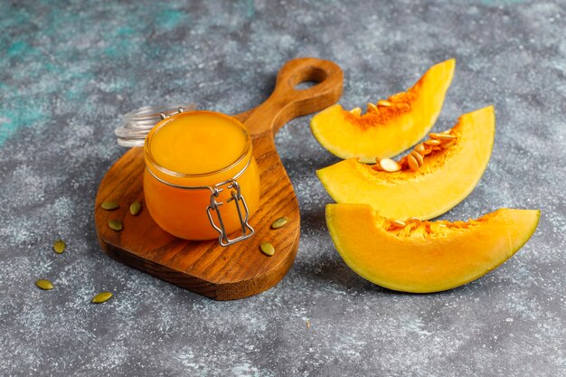 Homemade pumpkin puree with fresh pumpkin slices.