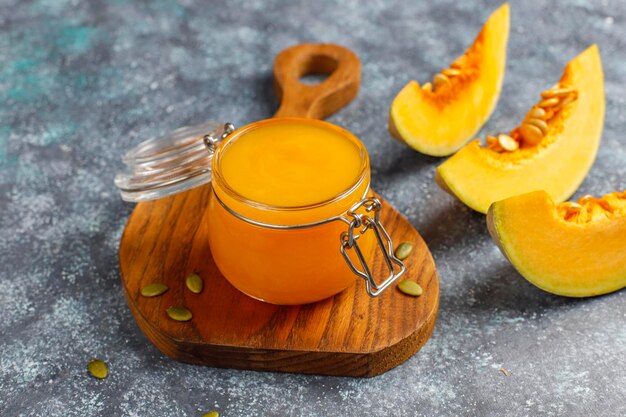 Homemade pumpkin puree with fresh pumpkin slices.