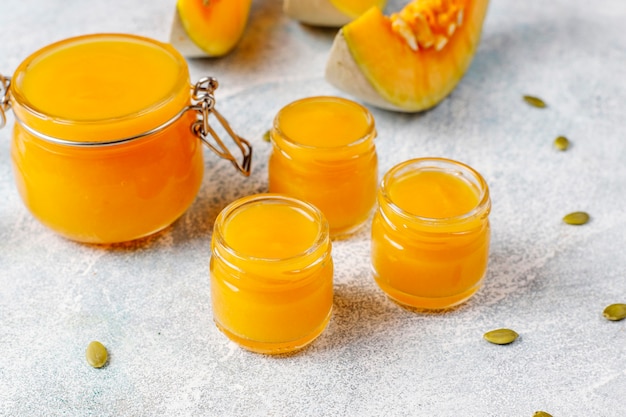 Homemade pumpkin puree with fresh pumpkin slices.