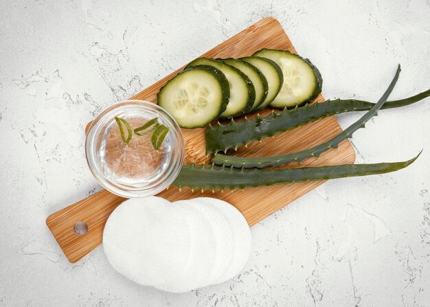 Free photo homemade remedy with wooden board cucumber, aloe vera for dark spots