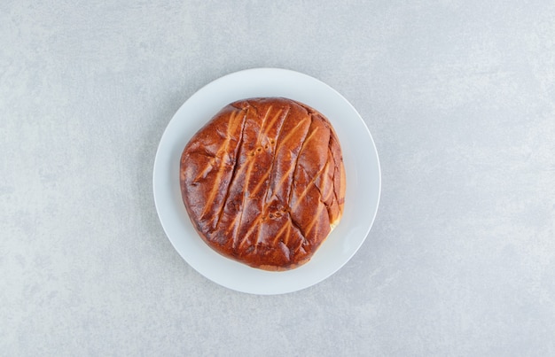 Free photo homemade round pastry on white plate.