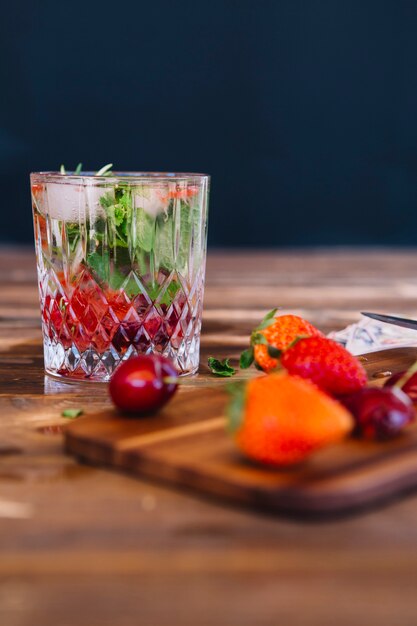 Homemade strawberry cocktail in glass on wooden desk