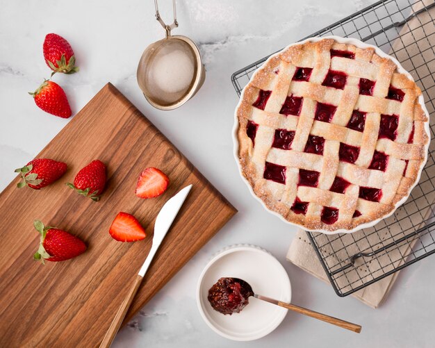 Homemade strawberry jam pie and slices of fruit