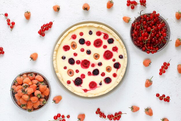 Homemade summer berry tar pie, different berries, golden raspberry, blackberry, red currant, raspberry and black currant, top view