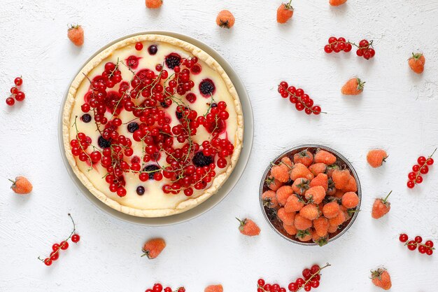 Homemade summer berry tar pie, different berries, golden raspberry, blackberry, red currant, raspberry and black currant, top view