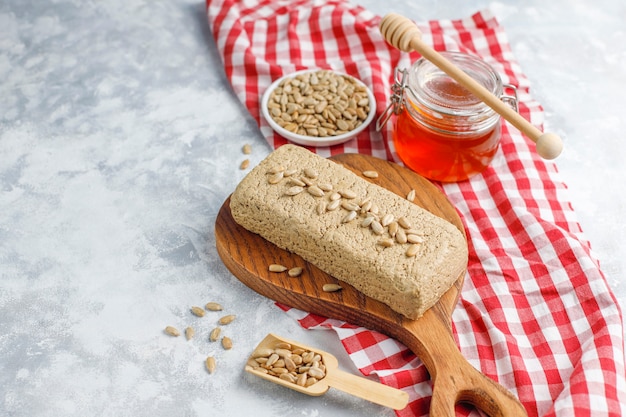 Free photo homemade sunflower halva on cutting board with sunflower seeds