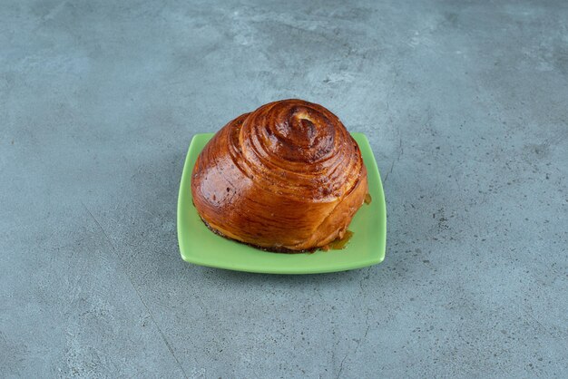 Homemade sweet pastry on green plate.