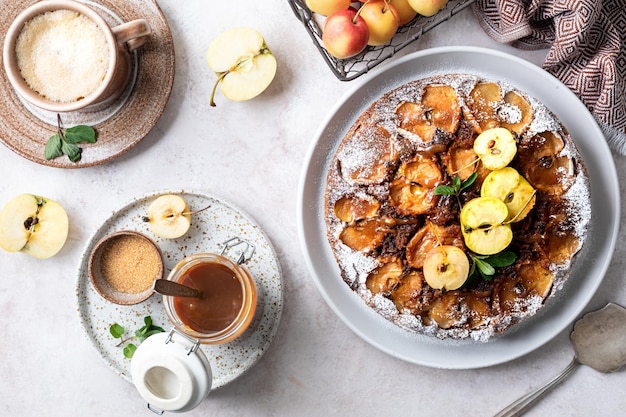 Free photo homemade tarte tatin pie with apples and nuts on a beige background french apple pie selective focus top view