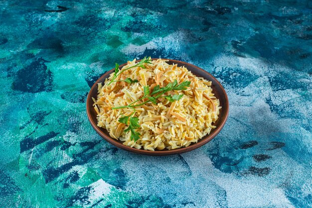 Homemade tasty noodle in a bowl, on the blue background. 