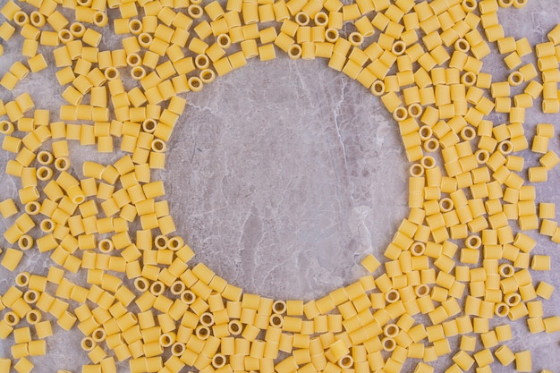 Homemade uncooked pastas isolated on the marble surface