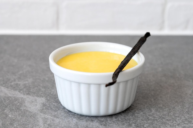 Homemade vanilla custard on wooden table background