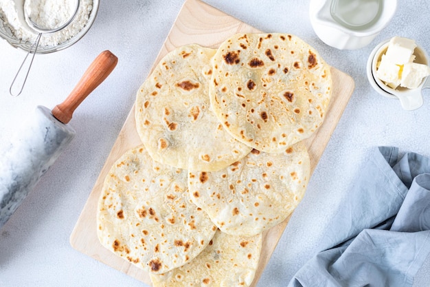 Free photo homemade wheat tortillas pita bread tortilla pita with ingredients for cooking on a white table top view