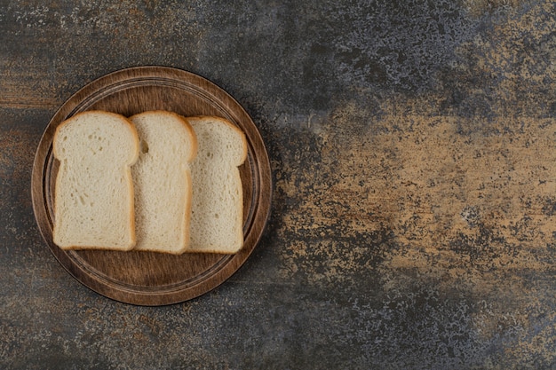 Fette di pane bianco fatto in casa sulla tavola di legno