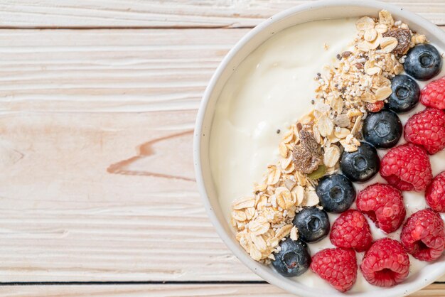 Homemade yogurt bowl with raspberry, blueberry and granola  - healthy food style