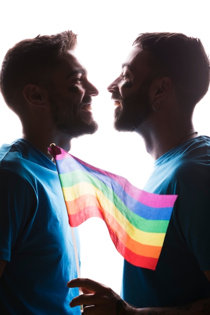 Homosexual couple with rainbow flag 