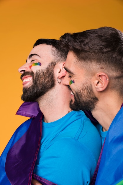 Free photo homosexual men lovingly hugging and touching each other