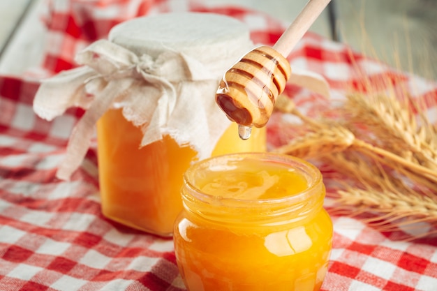 Premium Photo | Honey background. sweet honey in glass jar on wooden ...