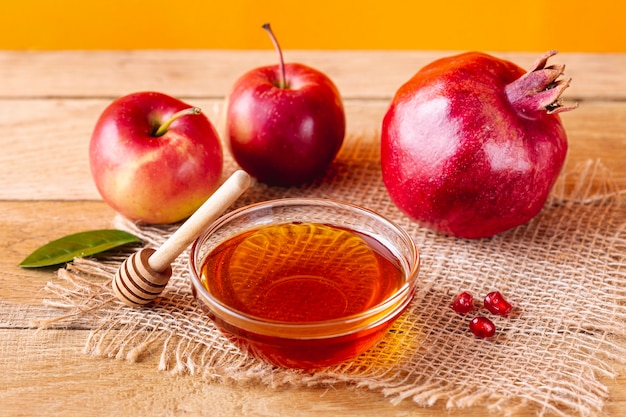 Honey bowl with dipper and fruits