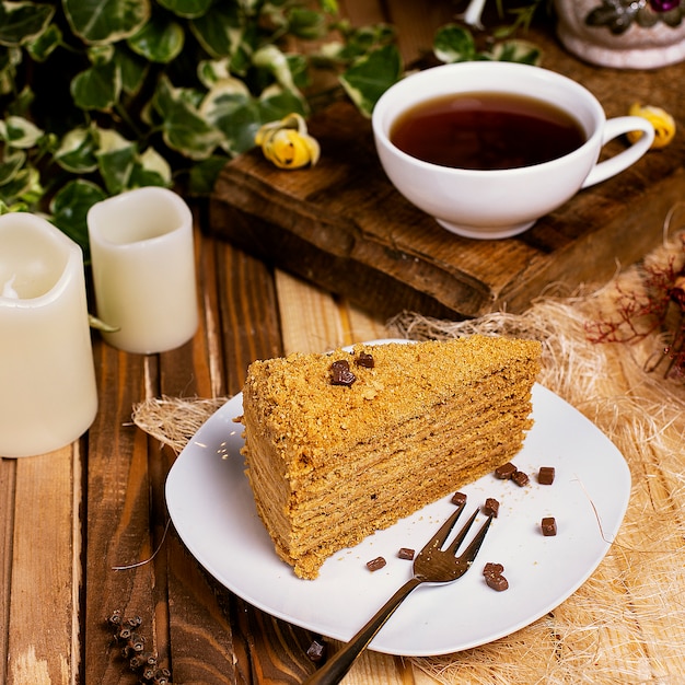 Honey cake, medovik slice with a cup of tea.