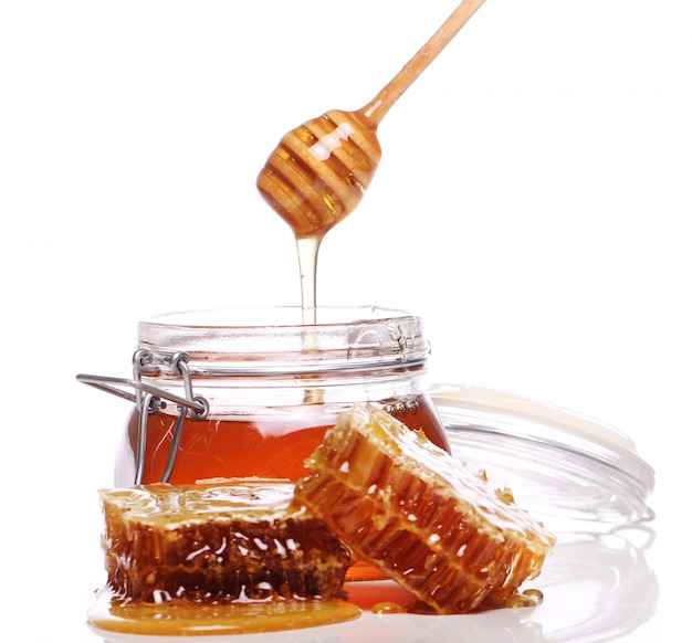 Honey dripping from a wooden spoon