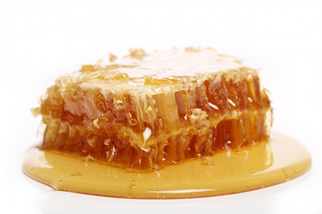 Honey dripping from a wooden spoon