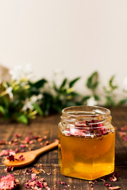 Free photo honey jar with petals