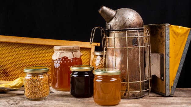 Honey jars with bee smoker and honeycomb