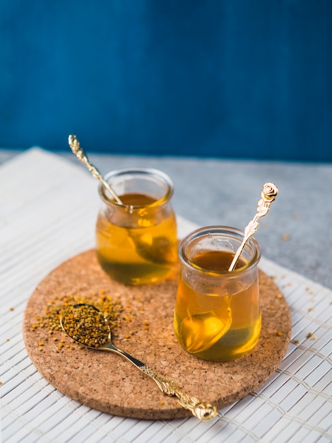 Honey pots and bee pollens on cork coaster