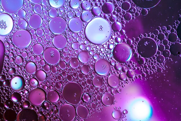 Honeycomb oil drops on purple hue