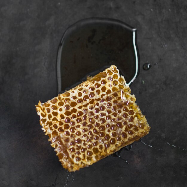 Honeycomb piece on black textured background