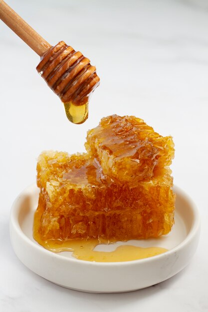 Honeycomb with beeswax and honey on plate