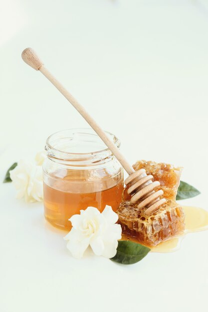 Honeycomb with jar and flowers