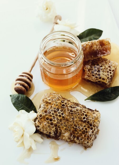 Honeycomb with jar and flowers