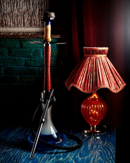 Free photo a hookah with red lamp