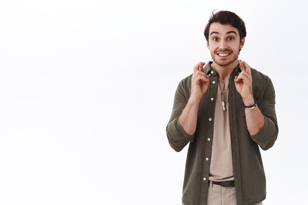 Hopeful excited hipster guy with beard and moustache, cant wait dream come true