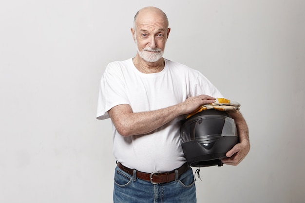 Horizontal image of elderly Caucasian male with thick gray beard posing in studio