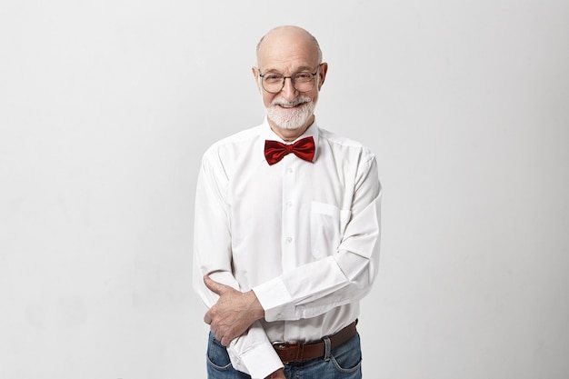 Horizontal image of handsome cheerful Caucasian elderly mature male with bald head